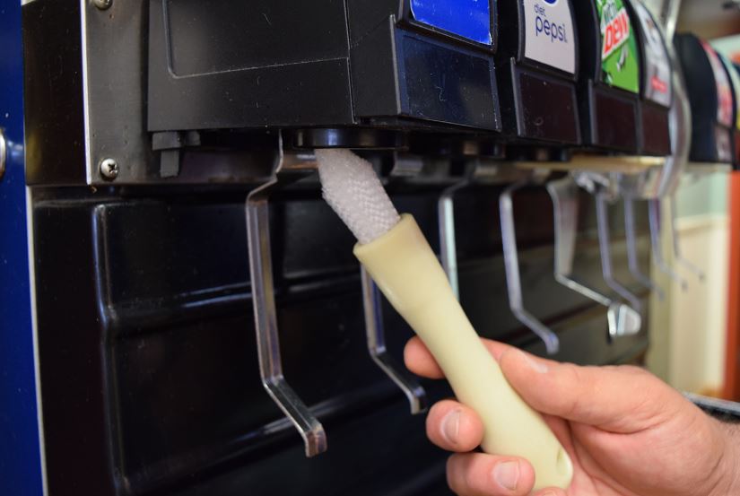 cleaning soda fountain nozzles with brush